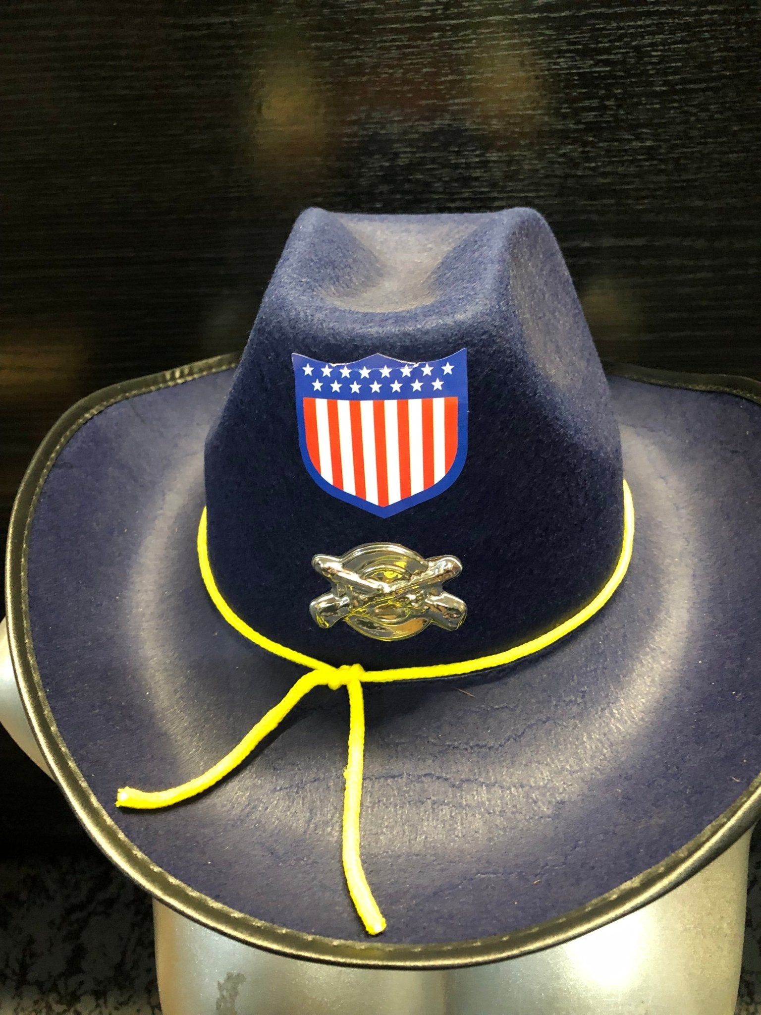 Sombrero de disfraz azul con parche patriótico, ribete amarillo y correa colgante