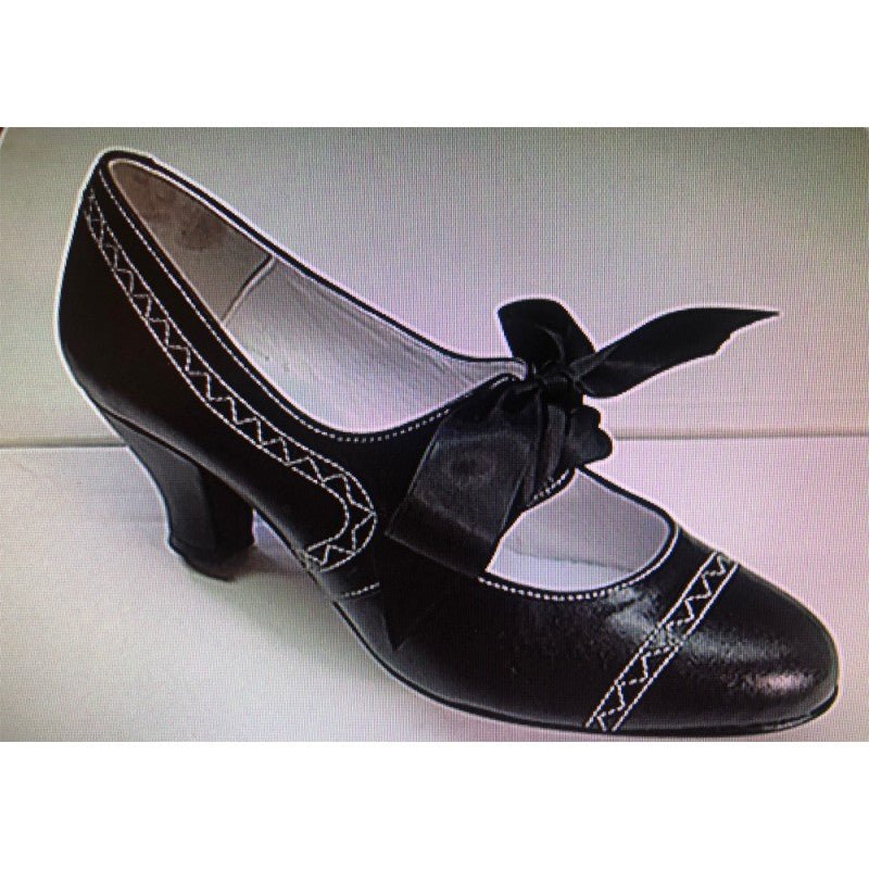 Zapato de mujer de tacón alto negro con moño frontal y costuras decorativas